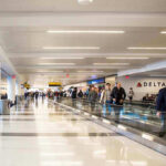 People walking through an airport terminal.