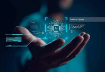 Hand holding digital AI and ChatGPT graphics.