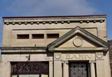 Trump’s Banking Order Sparks Immigration FURY Stone building facade with bank sign and columns