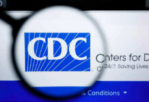 Top Fugitive Scientist EXTRADITED – CDC Fraud Exposed! CDC logo magnified on a screen.