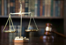 Scales of justice with gavel and books.