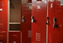 Woke Locker Room Turmoil Spurs DOJ Intervention Red lockers with padlocks, one open with hanger.