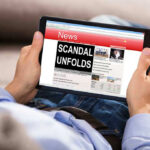 Wife’s Bombshell Triggers Campaign Meltdown Person reading tablet with headline Scandal Unfolds.