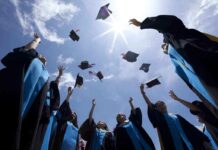 BOOED! Ex-Google Boss Sparks AI Backlash at Graduation Graduating students celebrating by throwing their caps into the air under a bright blue sky
