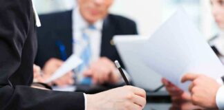 Close-up of a hand writing notes during a business meeting