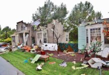 Shocking Excavator Assault Amid Marital Split Houses with significant storm damage and debris scattered around the yard