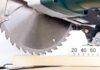 Close-up of a circular saw blade cutting through a piece of wood