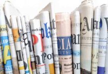 Attempt on Trump’s Life: Media to Blame? A collection of rolled newspapers displaying various headlines and designs