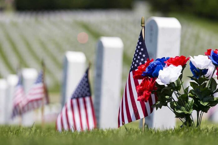 Veterans,Cemetery,Memorial,Celebration,With,American,Flag American flags and flowers placed at graves in a cemetery