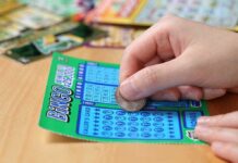 Lottery Karma: $586,000 Win After Returning $500 Ticket A person scratching off a bingo lottery ticket with a coin