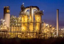 An industrial facility with illuminated structures at night