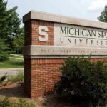 Musk’s Anti-College Stance Rocks Higher Ed Sign for Michigan State University surrounded by greenery