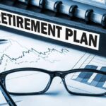Trump Launches Kids’ Accounts: $1,000 Gift Inside Close-up of a retirement plan binder with glasses and financial charts