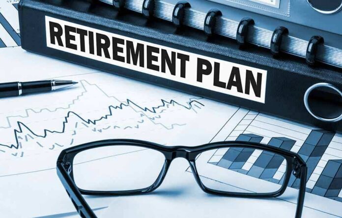 Close-up of a retirement plan binder with glasses and financial charts