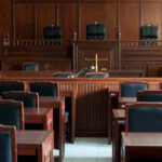 Lost Video Blows Up Sheriff Nominee Murder Case Empty courtroom with wooden furnishings and judges bench.