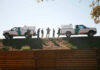 Border Patrol vehicles and agents on a ridge.