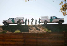 Border Lockdown Triggers Record Drug Hauls Border Patrol vehicles and agents on a ridge.