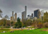City skyline with park and people relaxing.