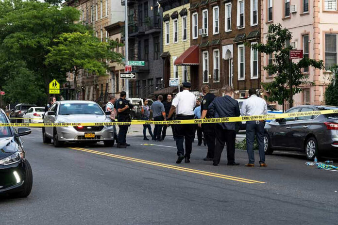 1437619223-1 Police gathered at an urban crime scene.