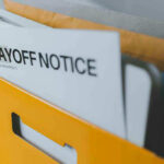 Manufacturing Guts Jobs, Blames AI Layoff notice in a yellow box.