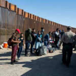 Ms. Rachel Sparks Detention Uproar Border patrol agents interact with a group of people.