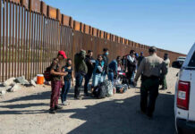 Ms. Rachel Sparks Detention Uproar Border patrol agents interact with a group of people.