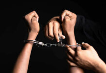 Appeals Bombshell Upends Tina Peters Case Handling handcuffs and unlocking with a key.