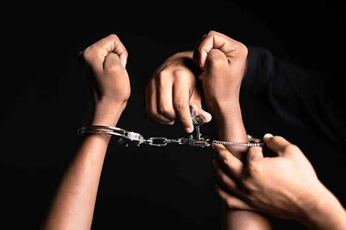 2160794121 Handling handcuffs and unlocking with a key.