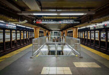 Penn Station BLOODBATH Sparks Panic Subway station platform with directional signs overhead.