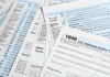 Six Billion at Risk — Over a Missing Line? Tax forms and documents overlapping on surface