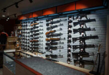 Gun Rush Erupts Before Virginia Ban Wall-mounted guns displayed in a store.