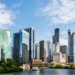 Troops To Chicago? Pritzker Dares Trump Chicago skyline featuring modern skyscrapers along a river
