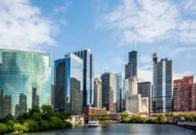 Troops To Chicago? Pritzker Dares Trump Chicago skyline featuring modern skyscrapers along a river