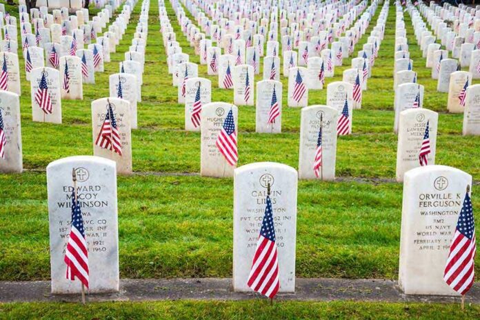 shutterstock_163155476 Rows of grave markers adorned with American flags in a military cemetery