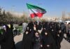 Hangings And Drones: What Tehran Hides Group of women in black attire marching with an Iranian flag