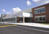 Minnesota Kid-Meal Millions: Fugitive Caught Modern school building with large windows and a clear sky