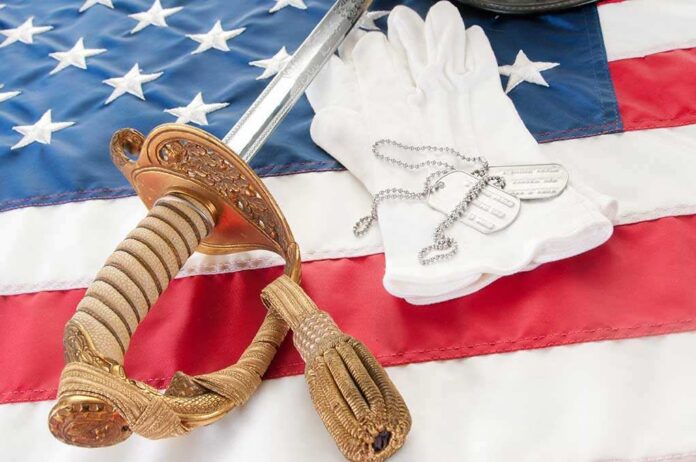 Dog,Tags,On,Military,Gloves,By,Sword A military sword, dog tags, and white gloves displayed on an American flag