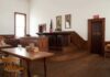 Federal Power Grab Hits Abortion Wars Interior of a historic courtroom with wooden furniture and an American flag