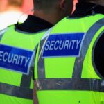 Electric Forest Shock: Baby Discovered Dead Two security personnel wearing high visibility vests with SECURITY printed on the back