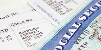 Close-up of a pay stub and a social security card