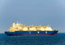 Hormuz Gamble Shocks Markets LNG tanker ship sailing on open sea.