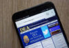 Unknown Caller, Real-Wallet Damage DEA website open on smartphone screen.