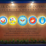Trillion-Dollar Weapons, Still Not Ready U.S. Department of Defense Security Cooperation display with logos.