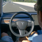 Dashboard Distraction: Lane Drift Surges Person using autopilot in Tesla on highway.