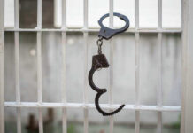 Goodwill Amid Airstrikes? Something Changed Handcuffs hanging on a barred window.