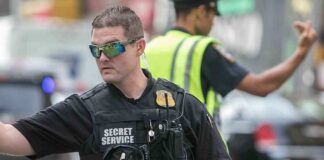 A Secret Service agent directing traffic in an urban setting