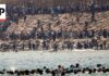 Thousands of migrants swim around the border from Morocco into Ceuta, Spain