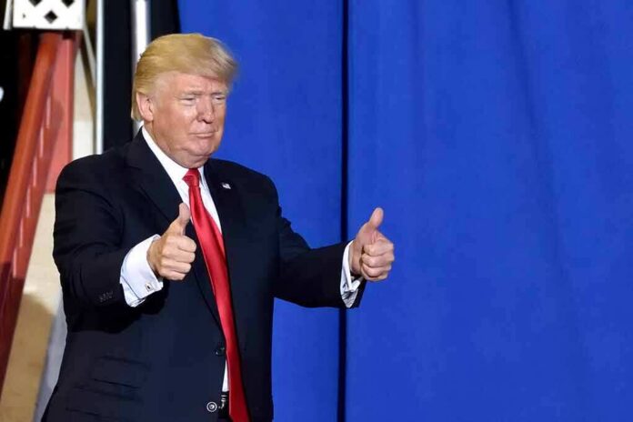 man in suit giving two thumbs up