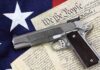 Patriotism Used To Push Gun Bans A handgun placed on top of the U.S. Constitution and an American flag