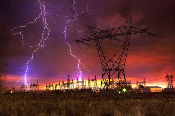 Dramatic,Image,Of,Power,Distribution,Station,With,Lightning,Striking,Electricity Lightning strikes illuminate a power station against a colorful sunset sky